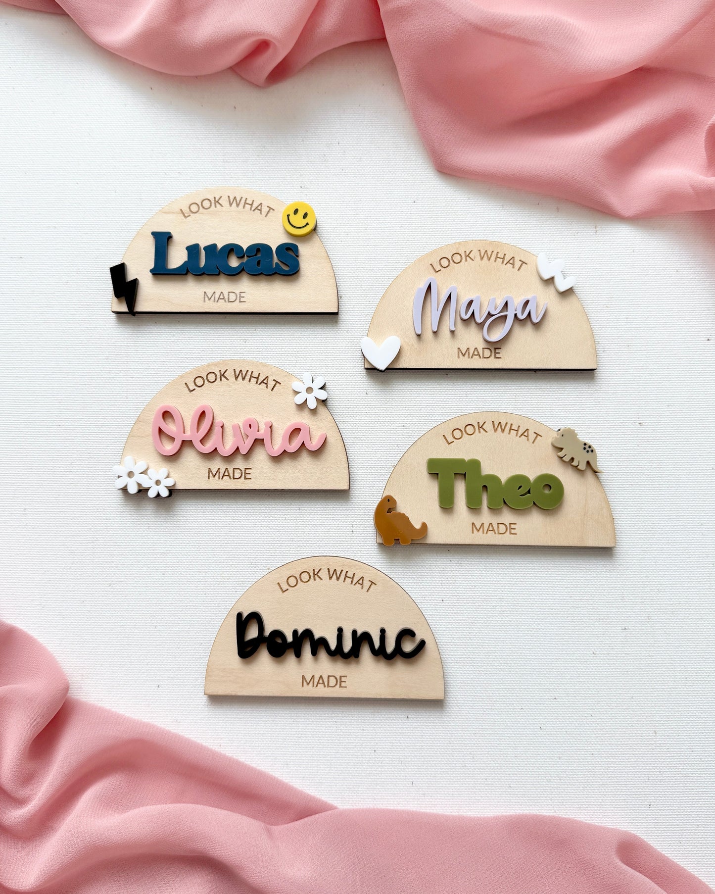 five personalized wood and acrylic magnets on a canvas background