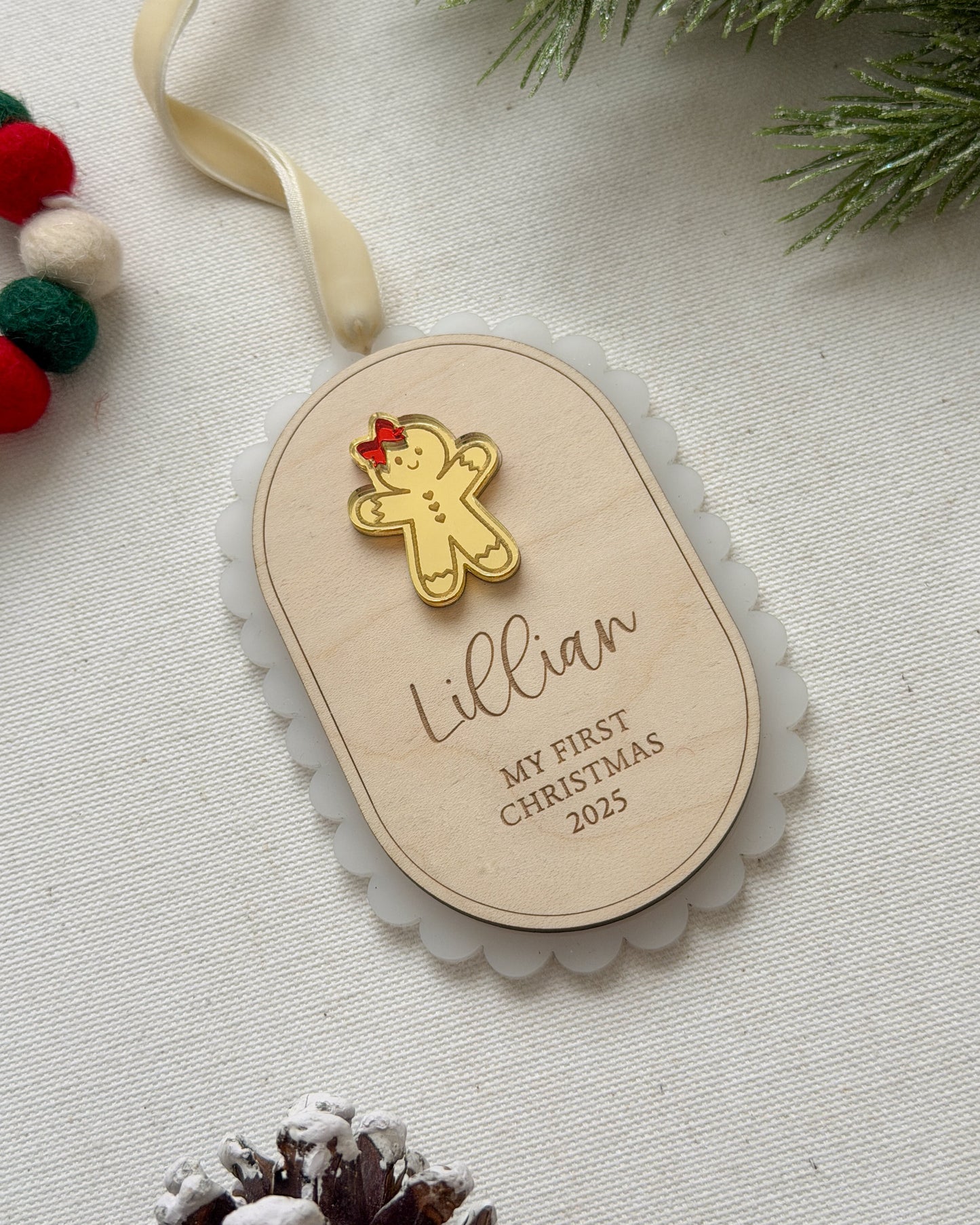 Personalized Christmas ornament with gingerbread man and 'Lillian' on a light background.