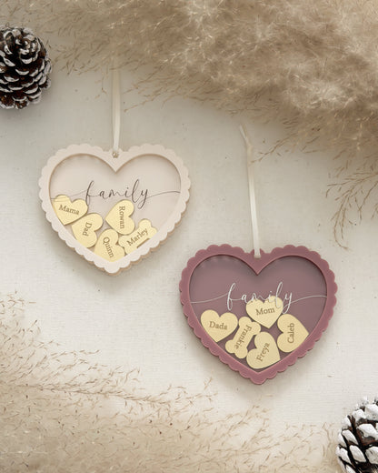 Heart-shaped decorative items with 'family' and heart designs on a textured surface.