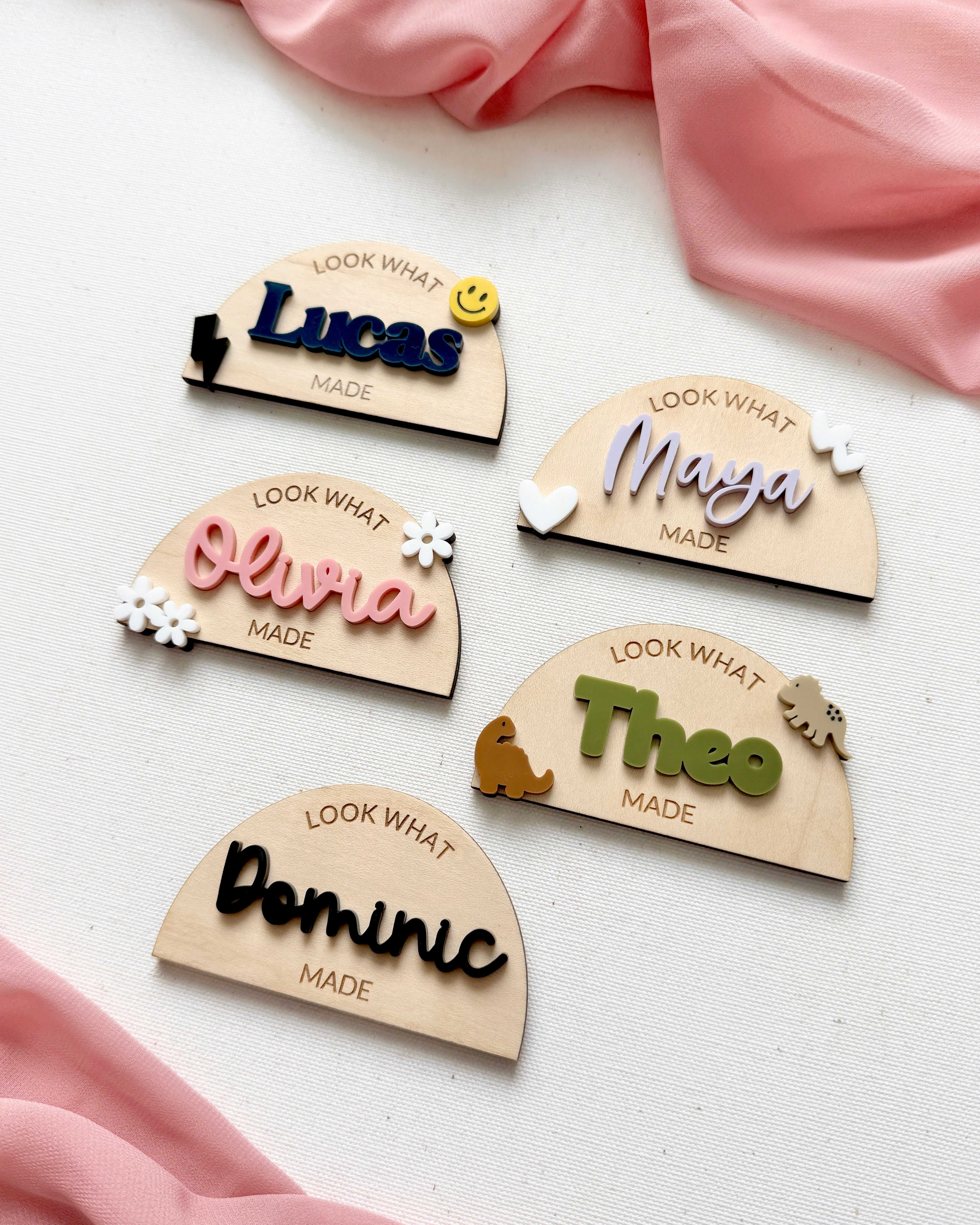 five personalized wood and acrylic magnets on a canvas background