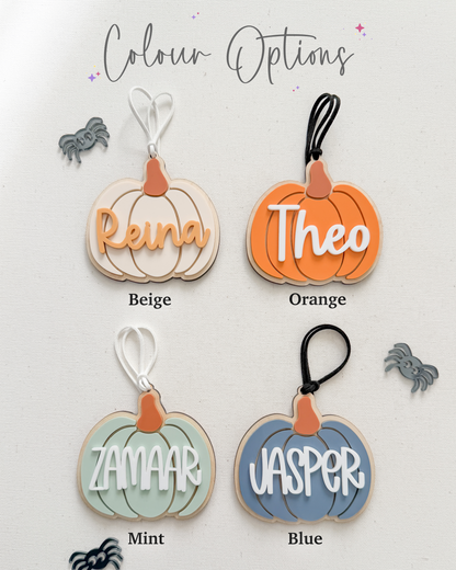 Four pumpkin-shaped keychains with names 'Reina', 'Theo', 'Zamaar', and 'Jasper' in different colors on a white background.