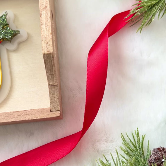 gold monogram Christmas ornament with a decorative glittery green mistletoe .